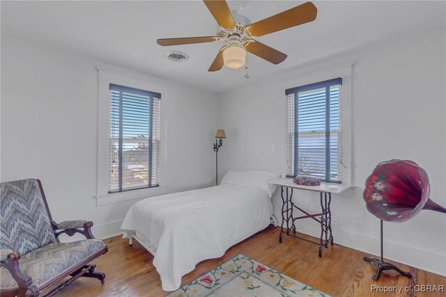159 Fleeton Point Cir, Reedville, VA 22539 - bedroom with wood finished floors, baseboards, and a ceiling fan
