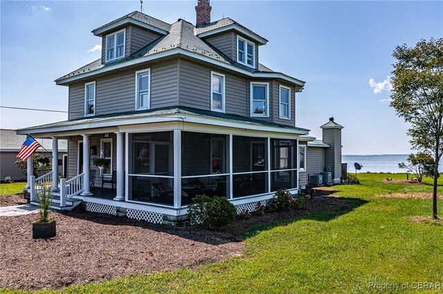 159 Fleeton Point Cir, Reedville, VA 22539 - view of front of home with a front yard, a water view, a sunroom, and a chimney
