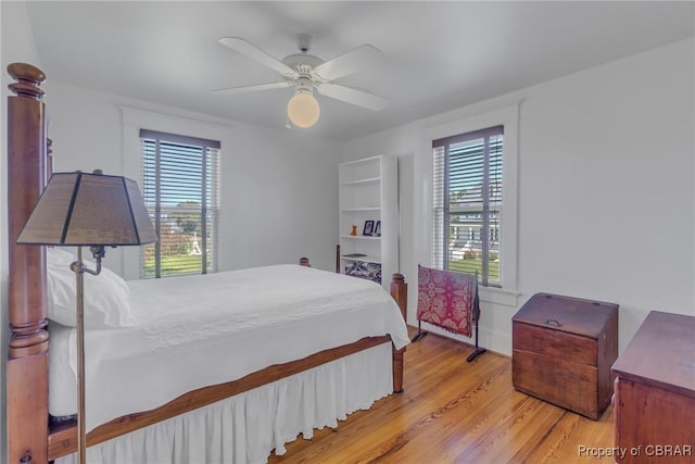 159 Fleeton Point Cir, Reedville, VA 22539 - bedroom with multiple windows, light wood-style flooring, and a ceiling fan