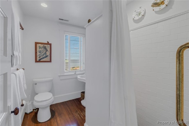 159 Fleeton Point Cir, Reedville, VA 22539 - bathroom featuring toilet, baseboards, wood finished floors, and a shower with curtain