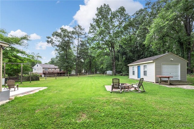 11911 Kilrenny Rd, Midlothian, VA 23113 - view of yard featuring an outdoor fire pit, an outdoor structure, a detached garage, and a patio area