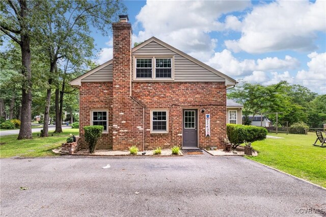11911 Kilrenny Rd, Midlothian, VA 23113 - view of front of house featuring a chimney, brick siding, and a front yard