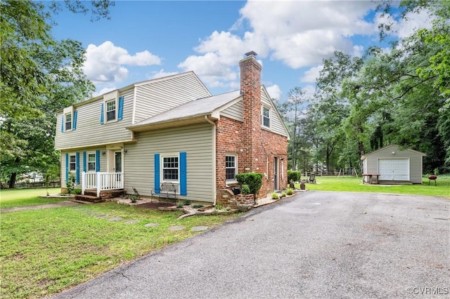 11911 Kilrenny Rd, Midlothian, VA 23113 - colonial-style house with an outdoor structure, a chimney, a front yard, a garage, and brick siding