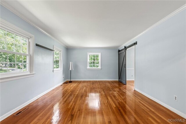 11911 Kilrenny Rd, Midlothian, VA 23113 - spare room with crown molding, hardwood / wood-style floors, baseboards, and a barn door