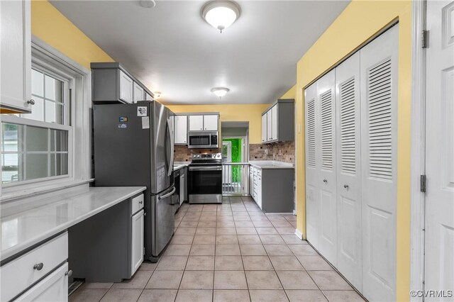 11911 Kilrenny Rd, Midlothian, VA 23113 - kitchen featuring stainless steel appliances, light tile patterned floors, light countertops, and decorative backsplash