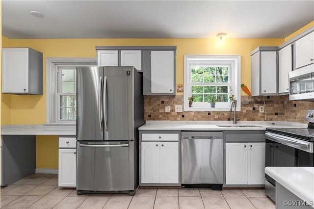 11911 Kilrenny Rd, Midlothian, VA 23113 - kitchen featuring appliances with stainless steel finishes, a sink, light tile patterned floors, light countertops, and decorative backsplash