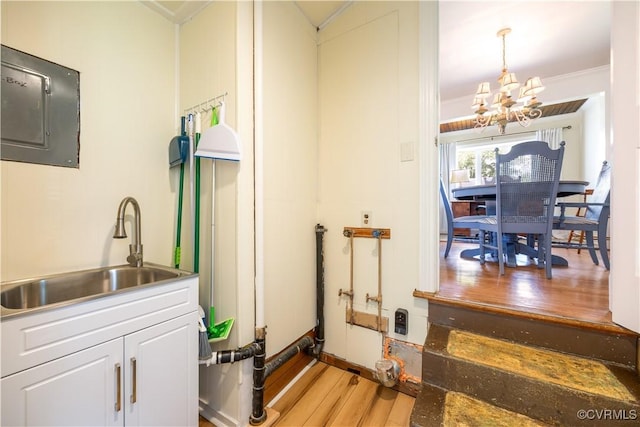 3513 Patrick Ave, Richmond, VA 23222 - washroom featuring a chandelier, electric panel, a sink, light wood-style floors, and ornamental molding