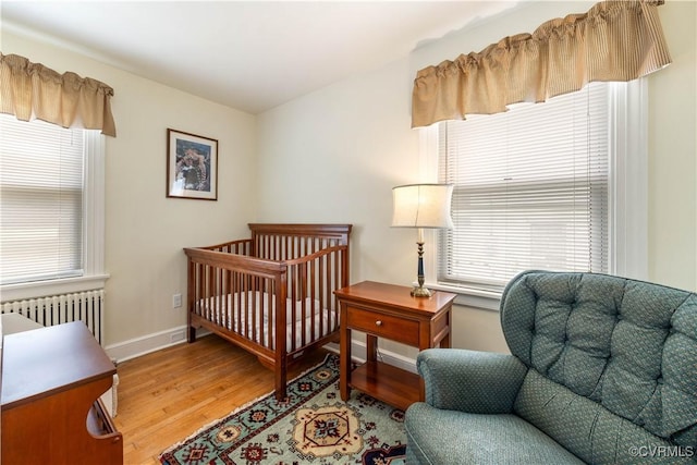 3513 Patrick Ave, Richmond, VA 23222 - bedroom featuring radiator heating unit, wood finished floors, multiple windows, and baseboards