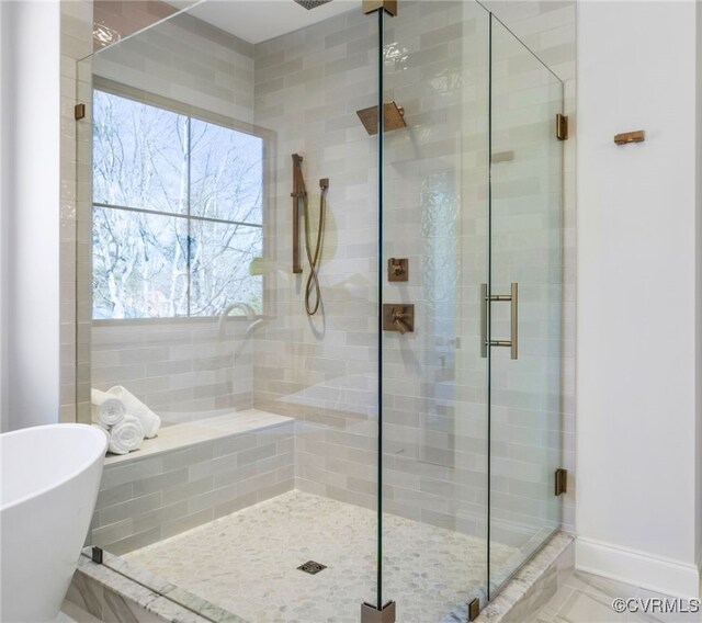 8900 Burkhart Dr, Henrico, VA 23229 - bathroom featuring a shower stall, a freestanding bath, and plenty of natural light