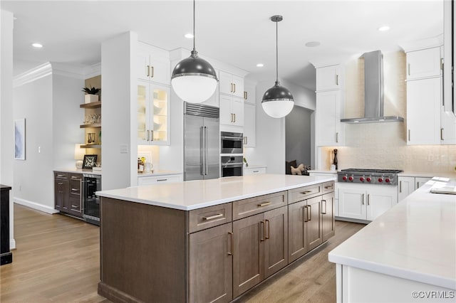 8900 Burkhart Dr, Henrico, VA 23229 - kitchen featuring wall chimney exhaust hood, stainless steel appliances, beverage cooler, light wood finished floors, and tasteful backsplash