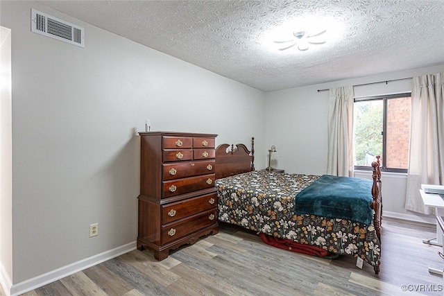 1500 Largo Rd Unit 201, Henrico, VA 23238 - bedroom with wood finished floors, a textured ceiling, and baseboards