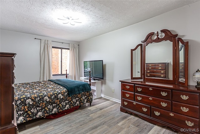 1500 Largo Rd Unit 201, Henrico, VA 23238 - bedroom with light wood finished floors, a textured ceiling, and baseboards