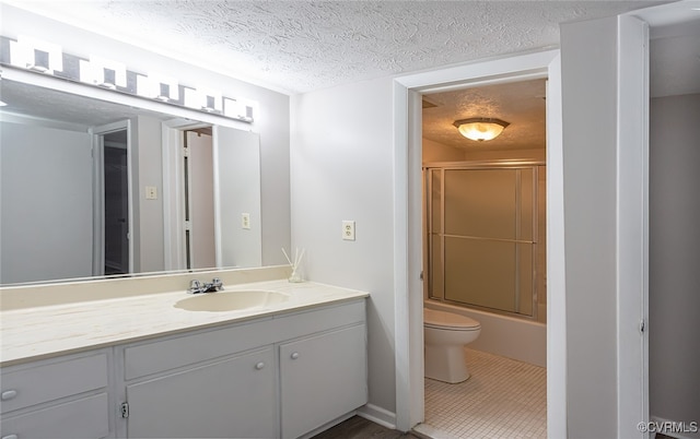 1500 Largo Rd Unit 201, Henrico, VA 23238 - bathroom featuring vanity, toilet, a textured ceiling, enclosed tub / shower combo, and tile patterned flooring
