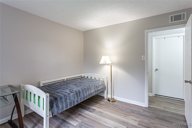 1500 Largo Rd Unit 201, Henrico, VA 23238 - bedroom with baseboards, wood finished floors, and a textured ceiling