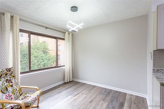 1500 Largo Rd Unit 201, Henrico, VA 23238 - living area featuring plenty of natural light, wood finished floors, a chandelier, and a textured ceiling