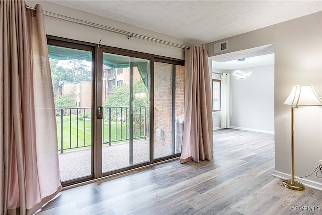 1500 Largo Rd Unit 201, Henrico, VA 23238 - doorway to outside featuring a textured ceiling, wood finished floors, and baseboards