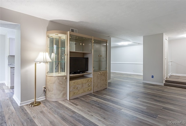 1500 Largo Rd Unit 201, Henrico, VA 23238 - unfurnished living room featuring wood finished floors, baseboards, and a textured ceiling