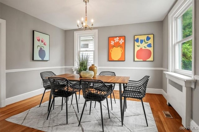 3204 Griffin Ave, Richmond, VA 23222 - dining room with a chandelier, wood finished floors, and baseboards