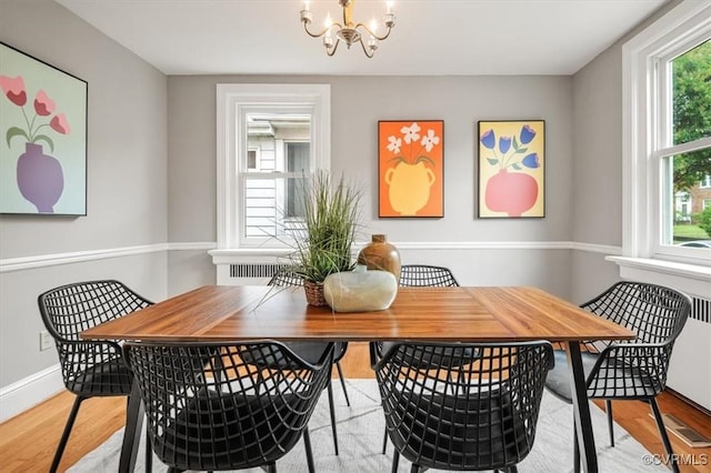 3204 Griffin Ave, Richmond, VA 23222 - dining area with light wood-type flooring, a chandelier, and baseboards