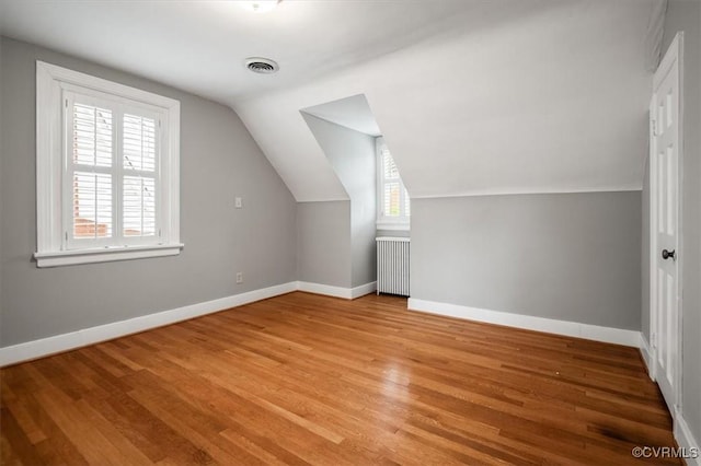 3204 Griffin Ave, Richmond, VA 23222 - additional living space with radiator, light wood-style flooring, baseboards, and vaulted ceiling