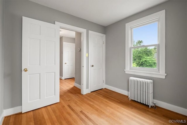 3204 Griffin Ave, Richmond, VA 23222 - unfurnished bedroom with radiator, baseboards, and light wood-style flooring