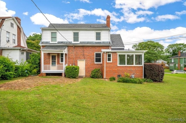 3204 Griffin Ave, Richmond, VA 23222 - back of house featuring brick siding, a lawn, and a chimney