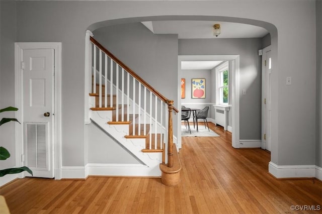 3204 Griffin Ave, Richmond, VA 23222 - stairs featuring wood finished floors, baseboards, arched walkways, and radiator heating unit
