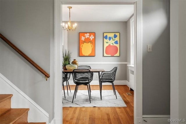 3204 Griffin Ave, Richmond, VA 23222 - dining area with wood finished floors, a chandelier, stairway, and baseboards