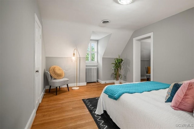 3204 Griffin Ave, Richmond, VA 23222 - bedroom featuring radiator heating unit, light wood-type flooring, baseboards, and lofted ceiling