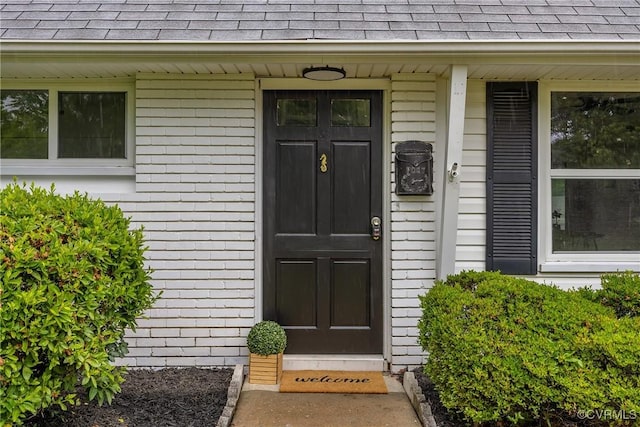 5612 Indigo Rd, Henrico, VA 23230 - view of exterior entry featuring a shingled roof and brick siding