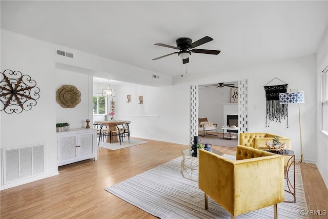 5612 Indigo Rd, Henrico, VA 23230 - living area with a ceiling fan, light wood finished floors, a glass covered fireplace, and baseboards