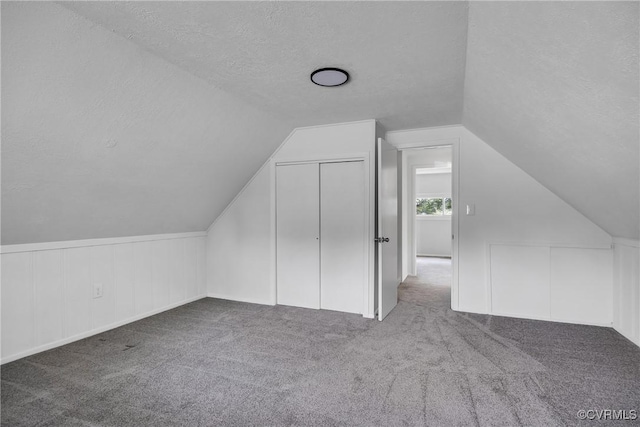 5612 Indigo Rd, Henrico, VA 23230 - additional living space with a textured ceiling, carpet floors, and vaulted ceiling