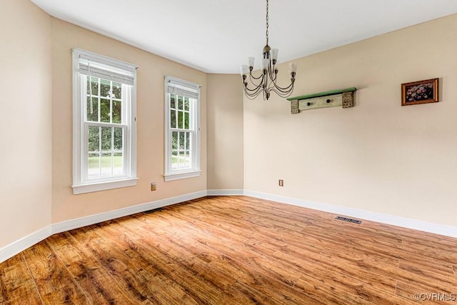 9214 Hunters Chase Dr, Mechanicsville, VA 23116 - spare room featuring a chandelier, wood finished floors, and baseboards