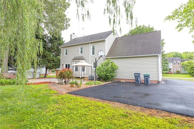9214 Hunters Chase Dr, Mechanicsville, VA 23116 - back of property with a chimney, a yard, central air condition unit, and a shingled roof