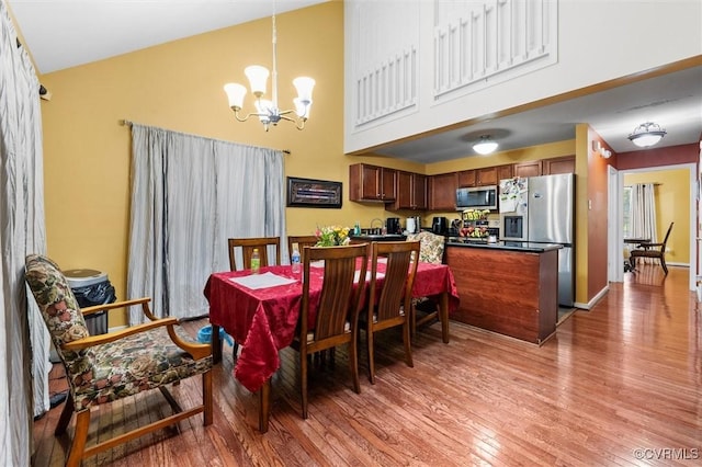 6207 Hackney Loop, Chesterfield, VA 23234 - dining room with a towering ceiling, a chandelier, and light wood finished floors