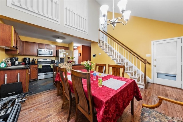 6207 Hackney Loop, Chesterfield, VA 23234 - dining area featuring a high ceiling, a chandelier, dark wood-type flooring, and stairway