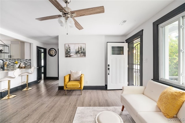 327 S 12th Ave, Hopewell, VA 23860 - living area featuring wood finished floors, a ceiling fan, and baseboards