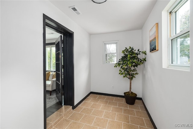 327 S 12th Ave, Hopewell, VA 23860 - corridor with plenty of natural light, baseboards, and light tile patterned floors