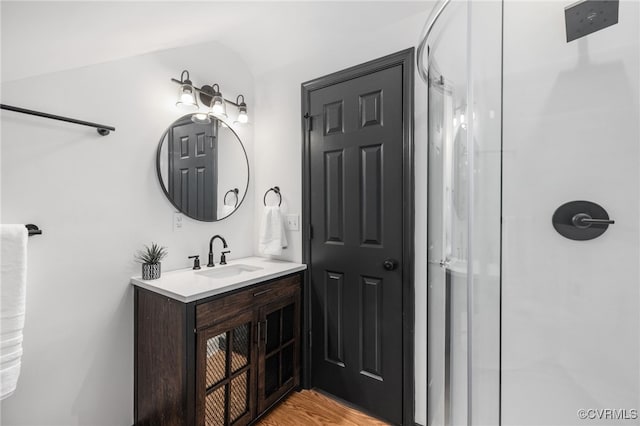 327 S 12th Ave, Hopewell, VA 23860 - bathroom with vanity, walk in shower, lofted ceiling, and wood finished floors