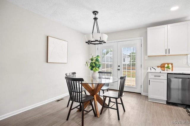 3207 Mark Rd, Richmond, VA 23234 - dining space with light wood-style flooring, baseboards, a chandelier, french doors, and a textured ceiling
