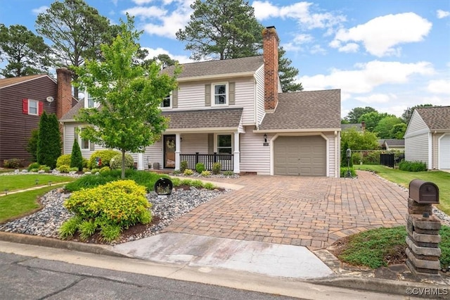 1146 Wicker Dr, Colonial Heights, VA 23834 - traditional-style house featuring a porch, an attached garage, decorative driveway, a chimney, and a shingled roof