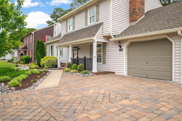 1146 Wicker Dr, Colonial Heights, VA 23834 - view of front of property with covered porch, an attached garage, a chimney, decorative driveway, and a shingled roof