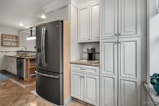 1146 Wicker Dr, Colonial Heights, VA 23834 - kitchen with appliances with stainless steel finishes, a sink, decorative backsplash, white cabinetry, and light tile patterned floors