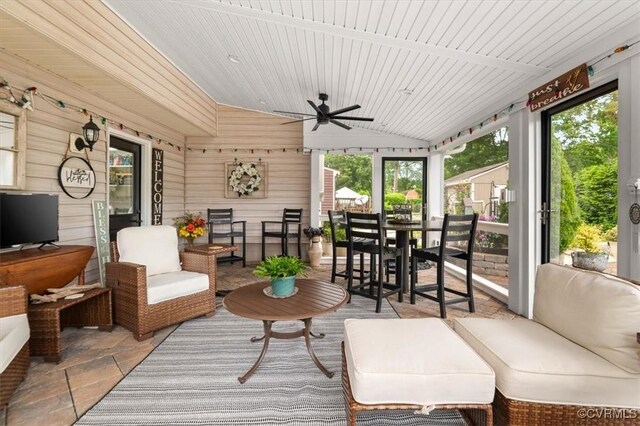 1146 Wicker Dr, Colonial Heights, VA 23834 - sunroom / solarium with a ceiling fan, vaulted ceiling, outdoor dining space, wooden walls, and outdoor lounge area