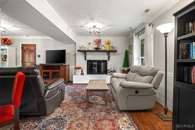 1146 Wicker Dr, Colonial Heights, VA 23834 - living room with a textured ceiling, crown molding, wood finished floors, and a fireplace