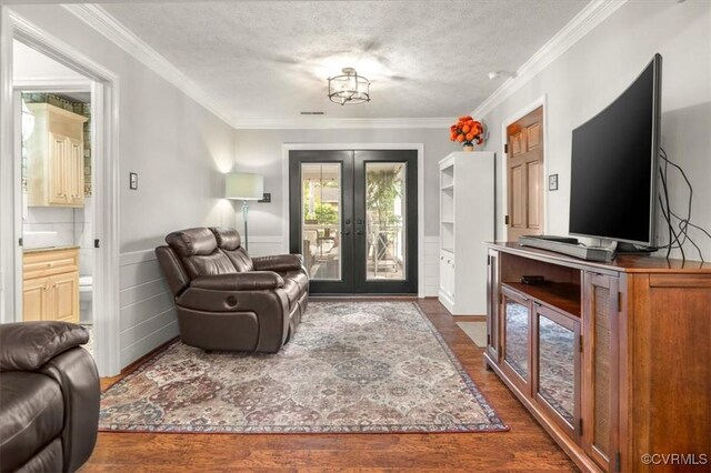 1146 Wicker Dr, Colonial Heights, VA 23834 - living area with french doors, dark wood-style floors, ornamental molding, a textured ceiling, and wainscoting