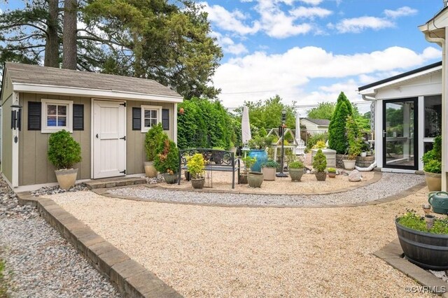 1146 Wicker Dr, Colonial Heights, VA 23834 - view of yard featuring an outbuilding, a sunroom, and a patio area