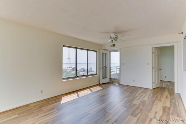 7505 River Rd Unit 4D, Newport News, VA 23607 - empty room with a ceiling fan, light wood-type flooring, and baseboards