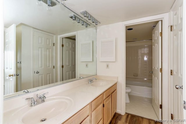 7505 River Rd Unit 4D, Newport News, VA 23607 - bathroom featuring toilet, double vanity, wood finished floors, and shower / washtub combination