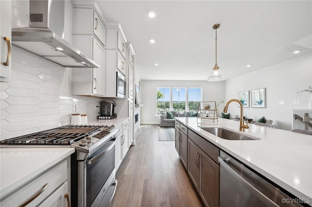 5427 Gillies Creek Mews, Henrico, VA 23231 - kitchen with stainless steel appliances, wall chimney exhaust hood, open floor plan, a sink, and recessed lighting